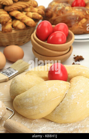 Easter sweet bread dough with red eggs Stock Photo