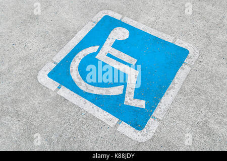 Blue disabled parking sign painted on dark asphalt in Canada in Ucluelet, Canada Stock Photo