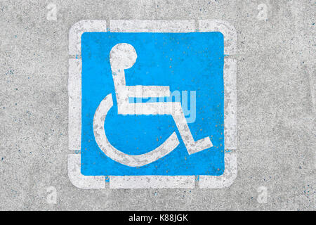Blue disabled parking sign painted on dark asphalt in Canada in Ucluelet, Canada Stock Photo