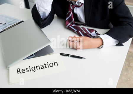 Feeling sick and tired. Frustrated middle aged businessman sitting at office desk Stock Photo