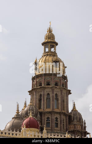 Mysore, India - October 27, 2013: closeup of central tower with golden domes of Mysore Palace. Lines of light bulbs , brown stones and more smaller do Stock Photo