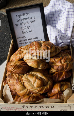 Swedish cinnamon buns 100 percent spelt on display in a London market on a bright sunny day Stock Photo