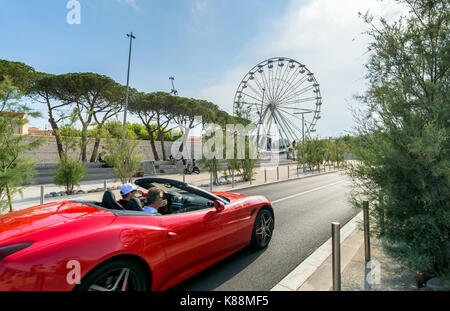 Antibes, France - July 01, 2016: day view of Ferrari supercar and grande roue in Antibes, France. Port Vauban is the largest marina in the Mediterrane Stock Photo