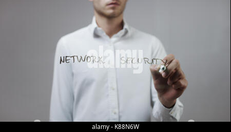 Network security , Man Writing on Glass Stock Photo