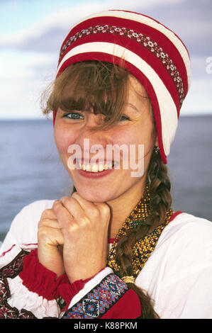 A pretty Russian woman in traditional country clothing along the Volga River in western Russia Stock Photo