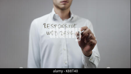Responsive web design , Man Writing on Glass Stock Photo