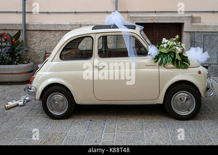 Small car adorned for wedding photographs in the old town in San Marino. Stock Photo