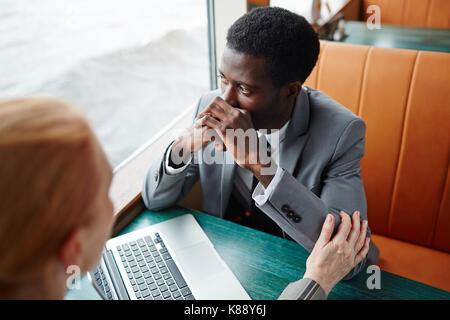 Businesswoman reassuring her stressed colleague during business travel Stock Photo