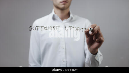 Software update , Man Writing on Glass Stock Photo