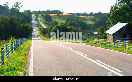 a long road through field and forest, landscape, top view, rise high above the fields and forests Stock Photo