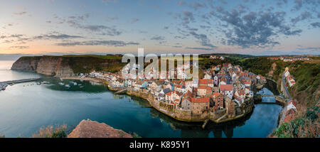 Panoramic image of a summer sunrise at Staithes from Cowbar Nab. Stock Photo