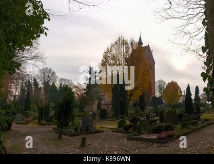 Bad Zwischenahn, Germany - November 23, 2016: Ancient cemetery at the church Stock Photo