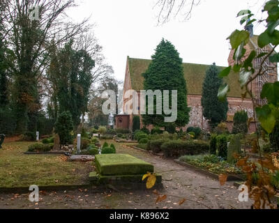 Bad Zwischenahn, Germany - November 23, 2016: Ancient cemetery at the church Stock Photo