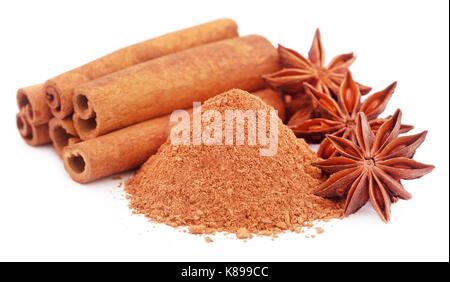 Some aromatic cinnamon with star anise and ground spice over white background Stock Photo