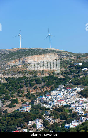 The small village of Skado, in mountainous central Naxos, with wind turbines on the mountain-tops above. Stock Photo