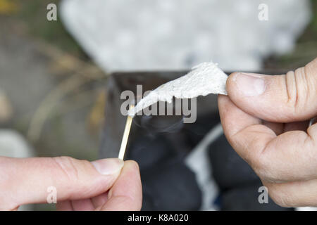 hands match paper Close-up macro hand male Stock Photo