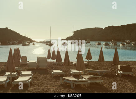 Empty deckchairs on the Cala Vadella beach in Ibiza Island. Balearic Islands. Spain Stock Photo
