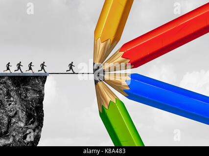 Group drawing a bridge and conquering adversity business concept as people running from a cliff with the help of a team of diverse pencils creating a  Stock Photo