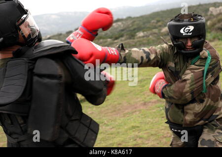 Legionnaires from the 2REP (2nd Foreign Paratroop Regiment) spar during an urban combat exercise in Fraseli, Corsica on March 25, 2010. Stock Photo