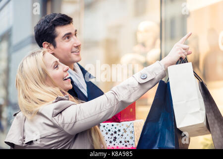 Couple at shop window doing Christmas shopping