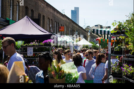 Tourists and locals jostle for space amongst the plants at Columbia Road Flower Market Stock Photo
