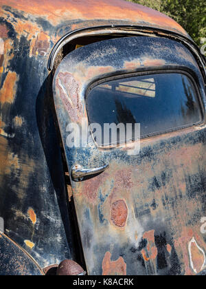 1950s junked & rusting Buick Eight ambulance back door. Stock Photo