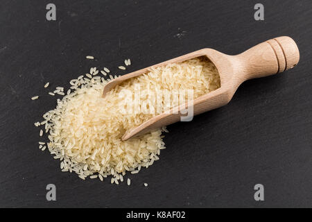 Scoop of rice on puffed rice cereal background close up Stock Photo