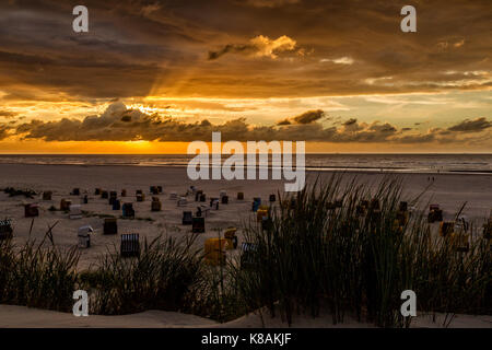 Sunset and dramatic sky over the beach on the north sea island Juist, East Frisia, Germany, Europe. Stock Photo