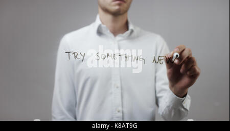 Try something new , Man Writing on Glass Stock Photo