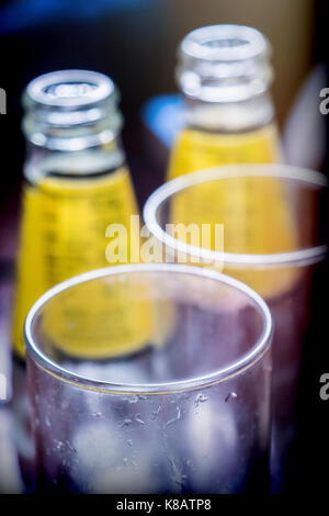 Two bottles along with two empty glasses Stock Photo