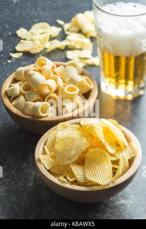 Crispy potato chips and rings in bowl. Salted potato chips. Stock Photo