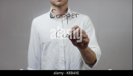 Copper Co , Man Writing on Glass Stock Photo