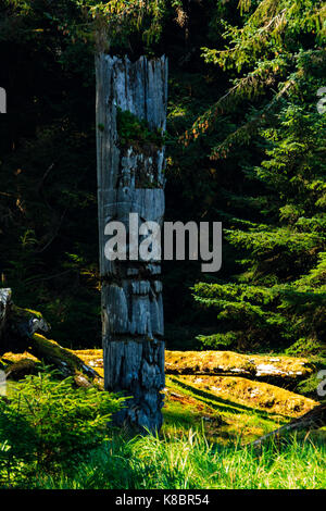 The funeral poles, also known as totem poles, in SGang Gwaay world heritage site, Haida Gwaii, First Nations, British Columbia, Canada Stock Photo