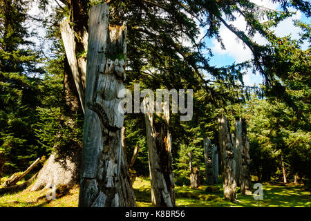 The funeral poles, also known as totem poles, in SGang Gwaay world heritage site, Haida Gwaii, First Nations, British Columbia, Canada Stock Photo