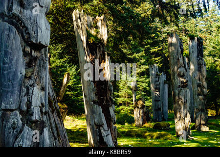 The funeral poles, also known as totem poles, in SGang Gwaay world heritage site, Haida Gwaii, First Nations, British Columbia, Canada Stock Photo