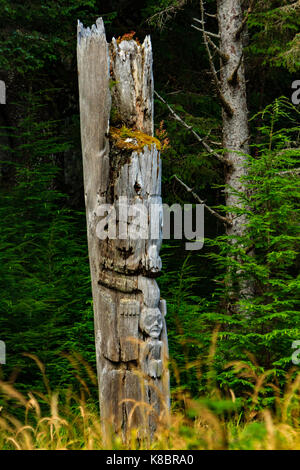 The funeral poles, also known as totem poles, in SGang Gwaay world heritage site, Haida Gwaii, First Nations, British Columbia, Canada Stock Photo