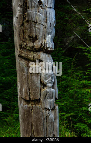 The funeral poles, also known as totem poles, in SGang Gwaay world heritage site, Haida Gwaii, First Nations, British Columbia, Canada Stock Photo