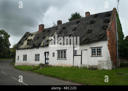 Thatched half timbered timber frame cottage in need of roof repairs, falling down, disused. Leicestershire UK 2017 2010s HOMER SYKES Stock Photo