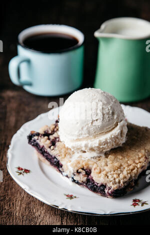 Homemade fresh blueberry cobbler with ice-cream on rustic background Stock Photo