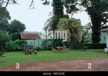 Coffee tables set up in a beautiful  garden at Wayanad Stock Photo