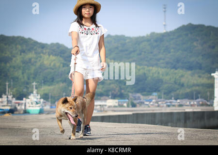 Girl with Shiba Inu Stock Photo