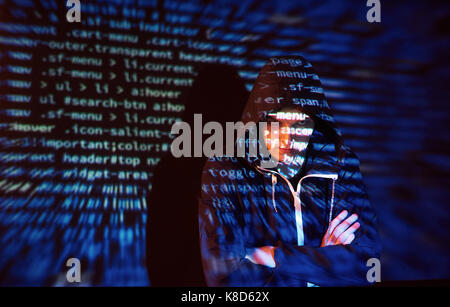 Cyber attack with unrecognizable hooded hacker using virtual reality, digital glitch effect Stock Photo