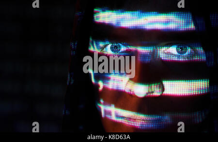 Cyber attack with unrecognizable hooded hacker using virtual reality, digital glitch effect Stock Photo