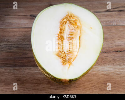 Green melon on wood background Stock Photo