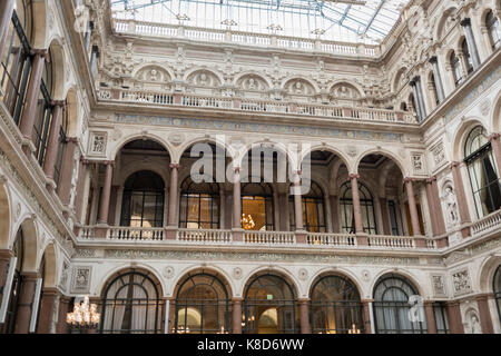 The architecture of the covered Durbar Court, inside the Foreign and Commonwealth Office (FCO) and part of the former India Office, on 17th September 2017, in Whitehall, London, England. The main Foreign Office building is in King Charles Street, and was built by George Gilbert Scott in partnership with Matthew Digby Wyatt and completed in 1868 as part of the new block of government offices which included the India Office and later (1875) the Colonial and Home Offices. George Gilbert Scott was responsible for the overall classical design of these offices but he had an amicable partnership with Stock Photo