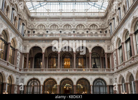 The architecture of the covered Durbar Court, inside the Foreign and Commonwealth Office (FCO) and part of the former India Office, on 17th September 2017, in Whitehall, London, England. The main Foreign Office building is in King Charles Street, and was built by George Gilbert Scott in partnership with Matthew Digby Wyatt and completed in 1868 as part of the new block of government offices which included the India Office and later (1875) the Colonial and Home Offices. George Gilbert Scott was responsible for the overall classical design of these offices but he had an amicable partnership with Stock Photo