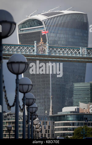 The British Union Jack flag flies from the high-level walkway of the Victorian-era Tower Bridge, near the modern Walkie Talkie building (aka 20 Fenchurch Street), on 14th September 2017, in London, England. Stock Photo
