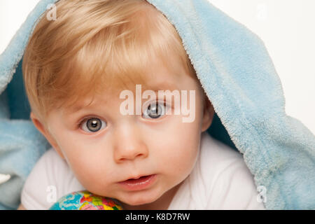 Baby boy holds small globe in his hands. Isolated on a white Stock Photo