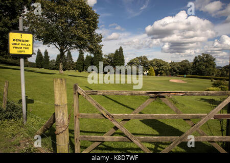 The 18th hole and green at Bingley St Ives Golf Club, at Harden, Bingley, Nr Bradford, Yorkshire, UK with a 'golf balls from the left' sign Stock Photo