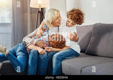Careful granny playing with children at home Stock Photo